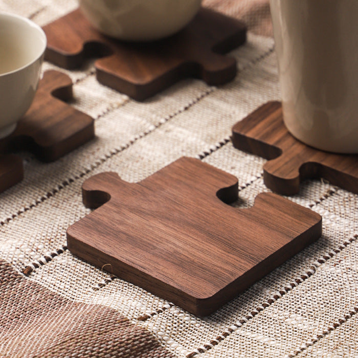 Walnut coasters on a striped linen runner with tea ware